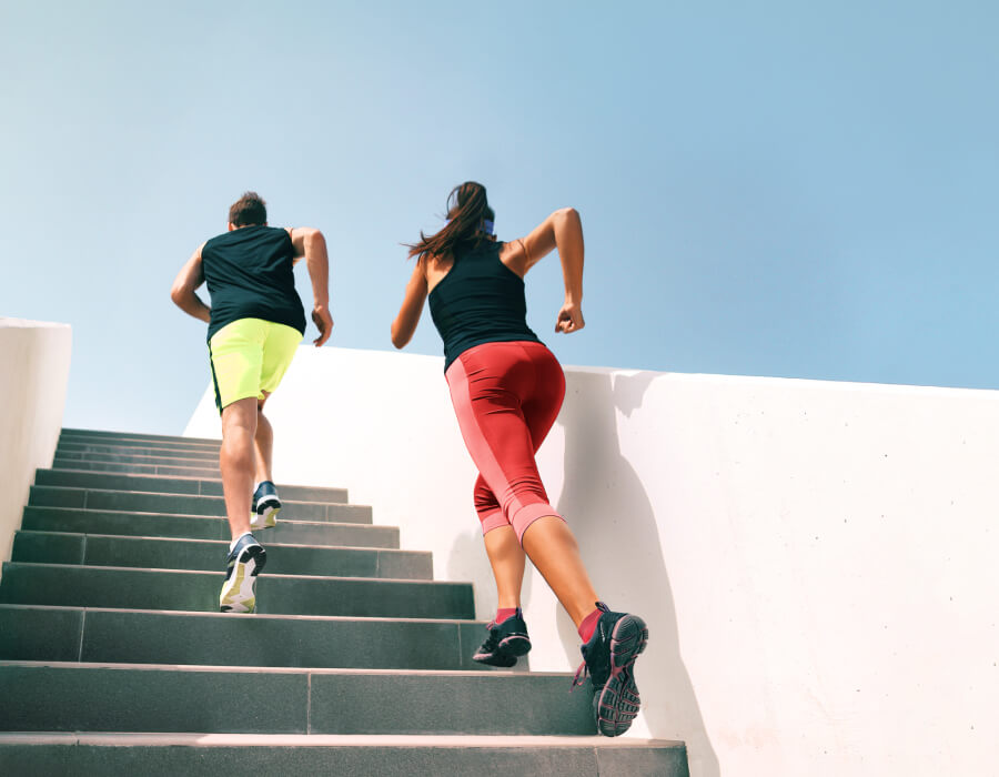 Two people running up stairs