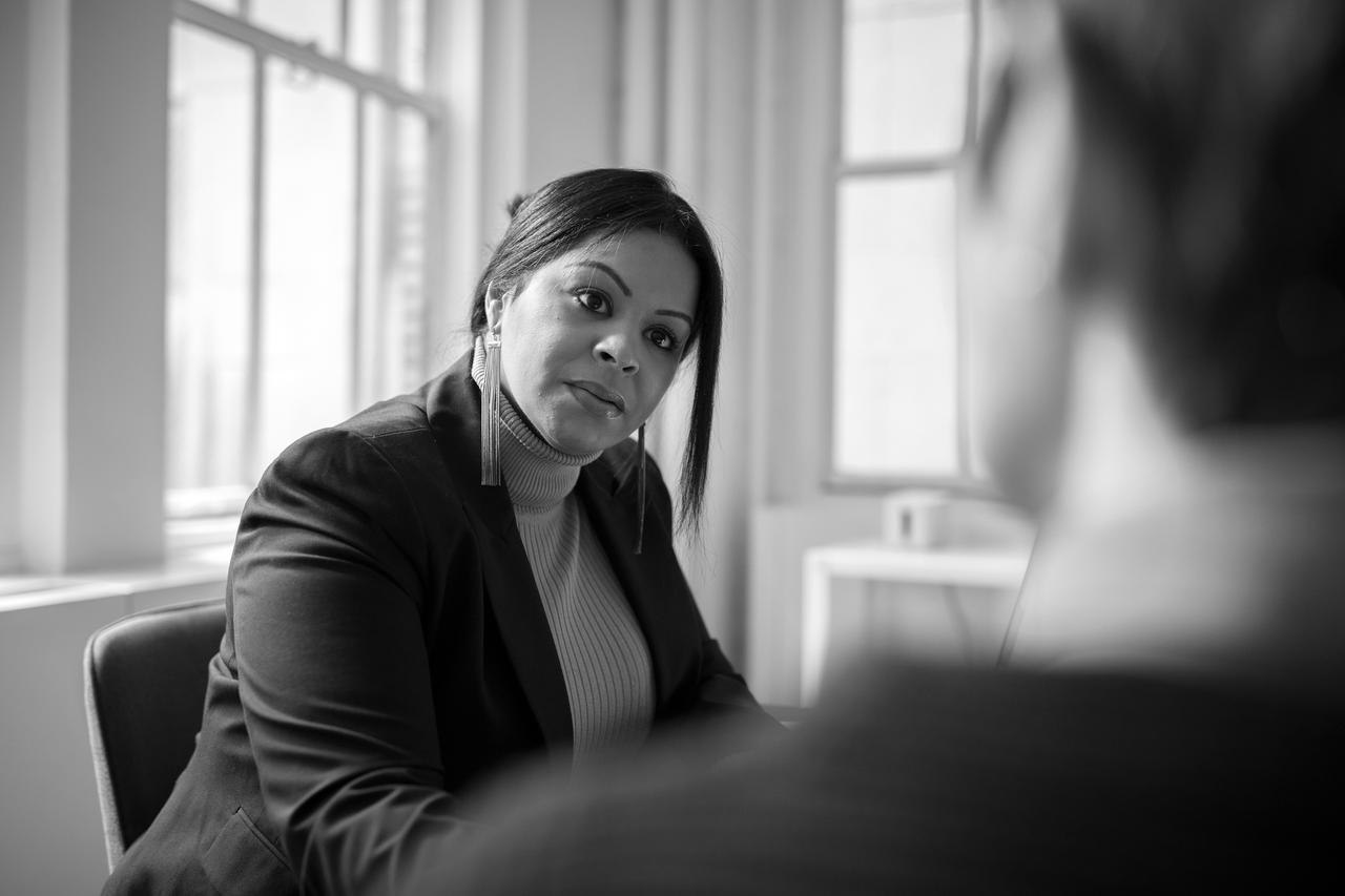 A woman sitting in a business meeting listening