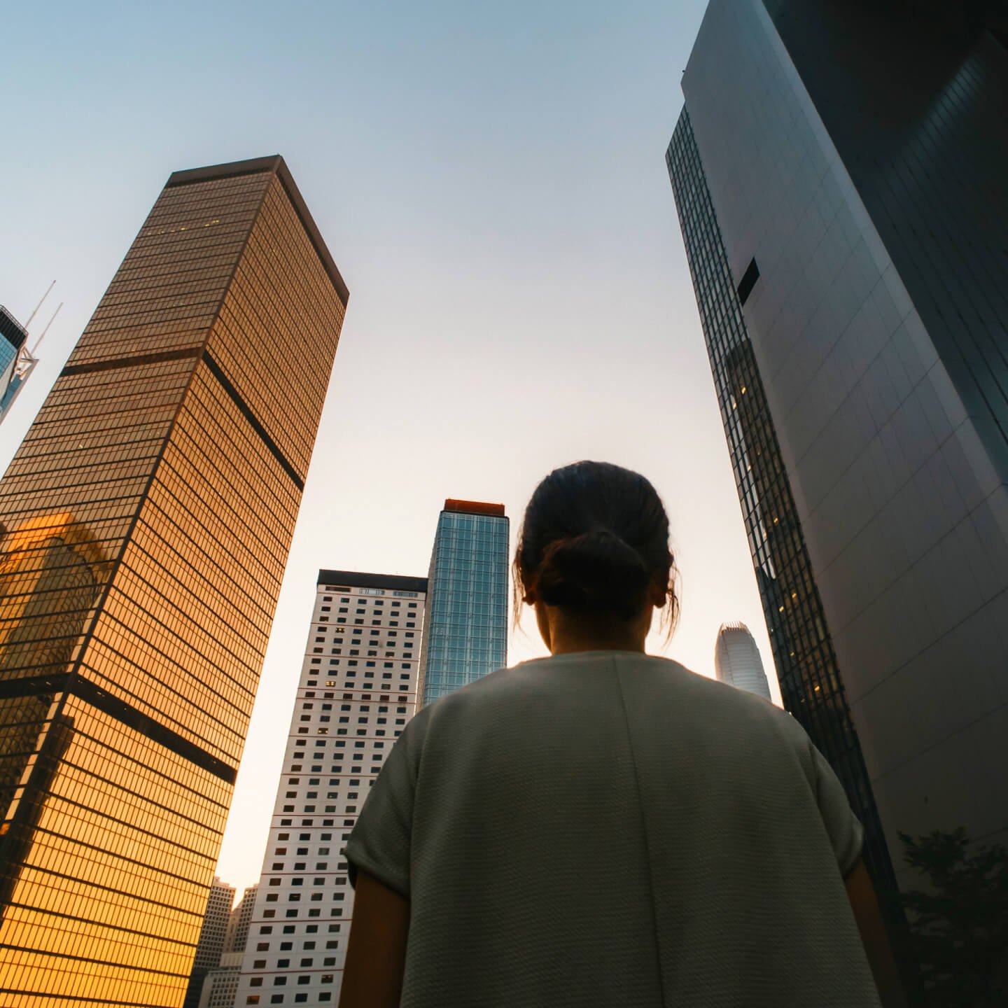 A business women looking up at buildings