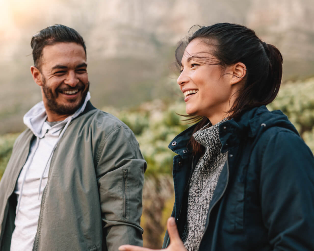 A young couple having a conversation in nature.