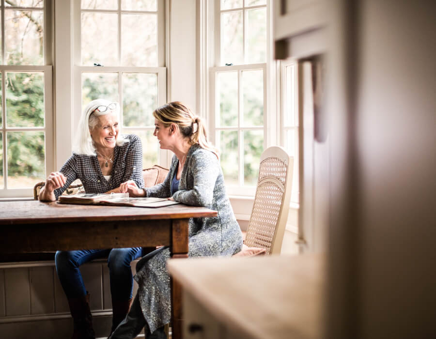 Two women having conversation at table