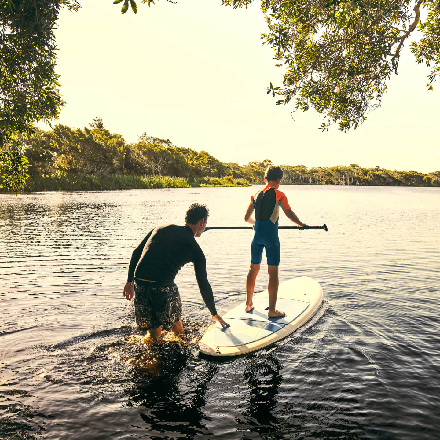Father and son paddleboarding