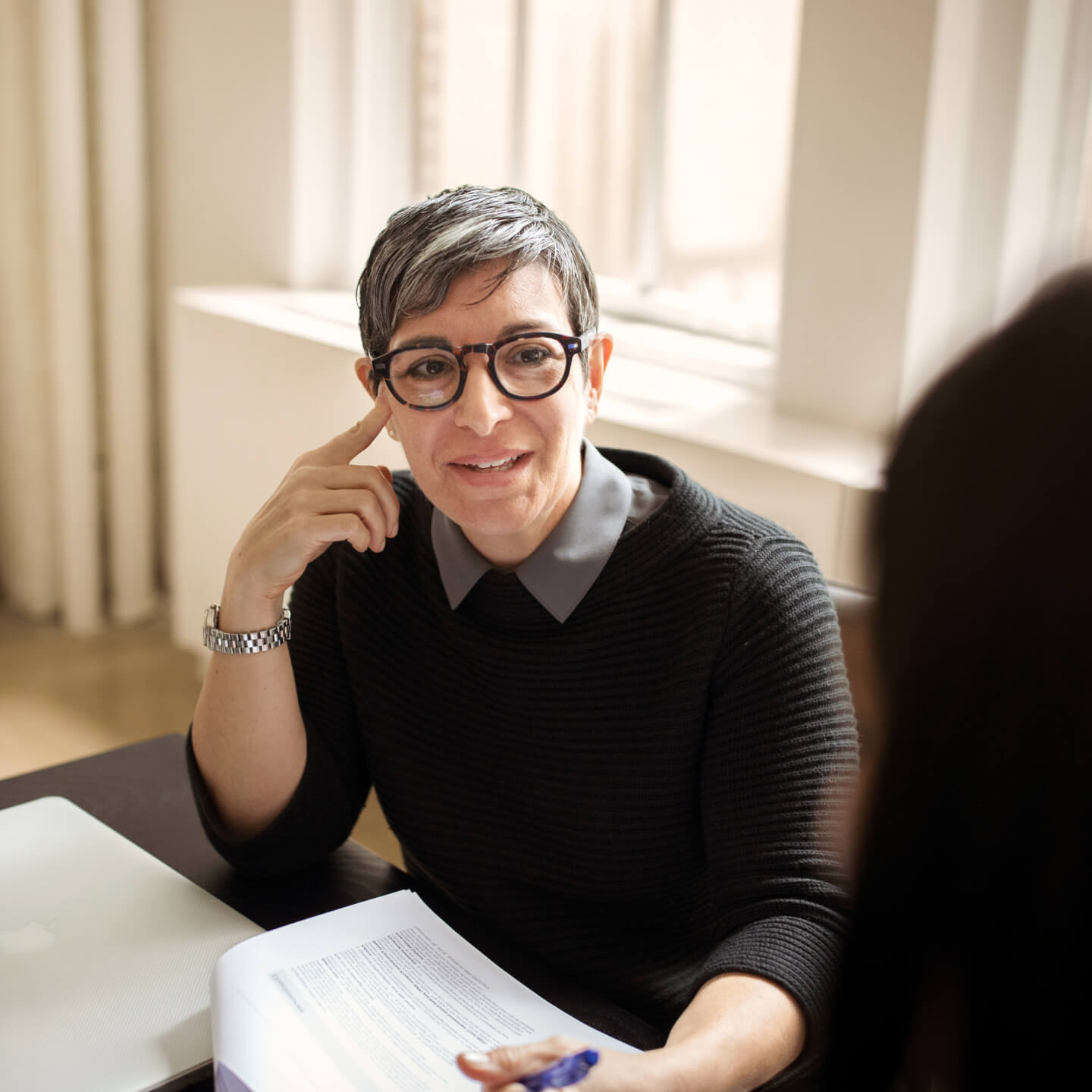 Female worker has conversation with coworker