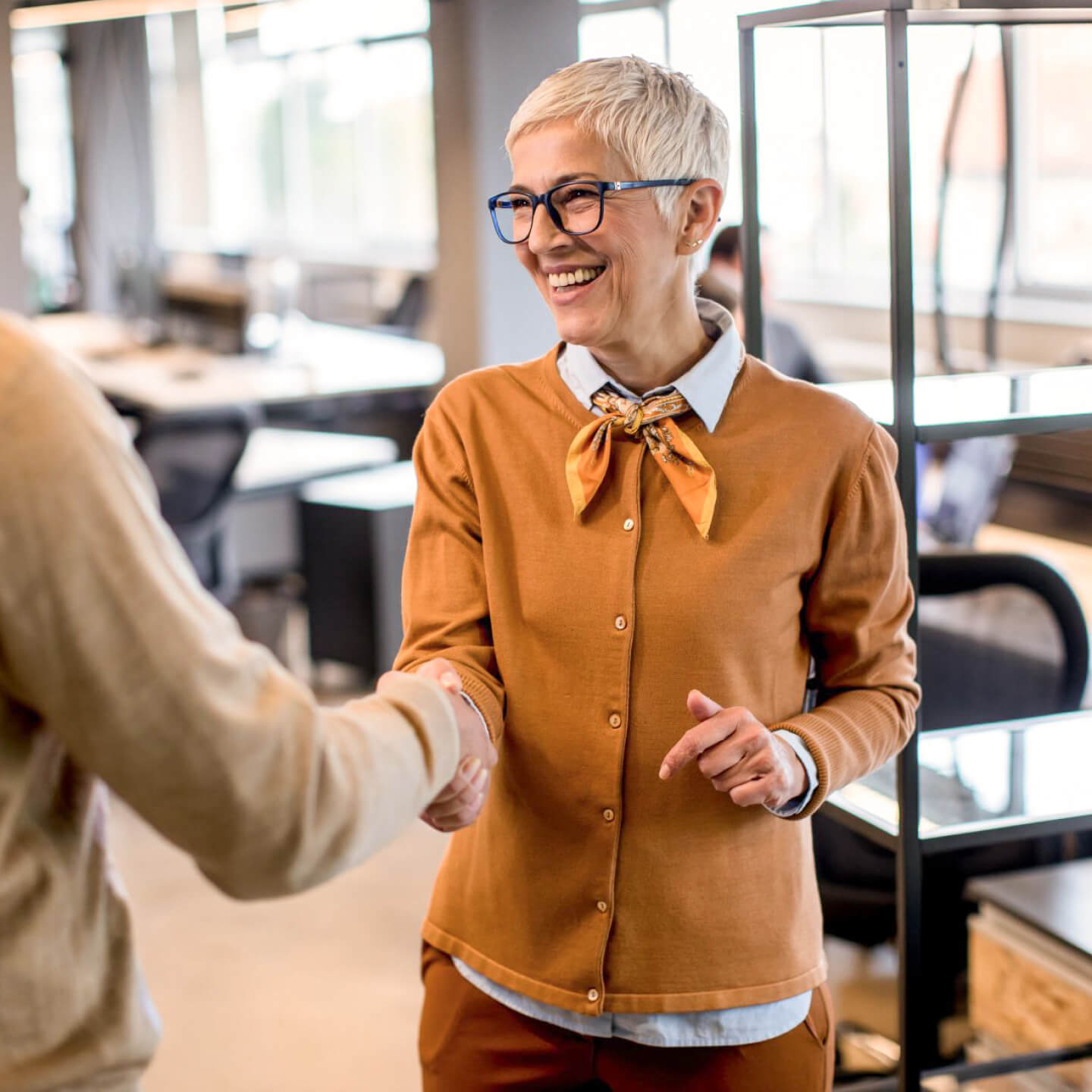 Woman in office shaking hands