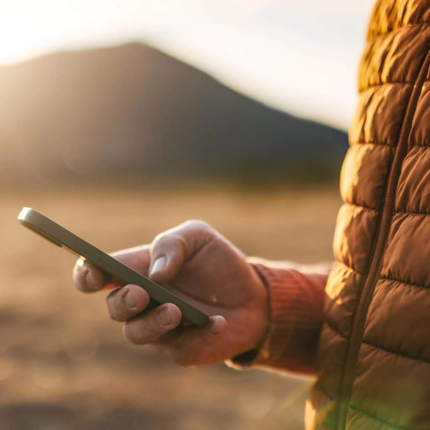 Man outside looking at mobile