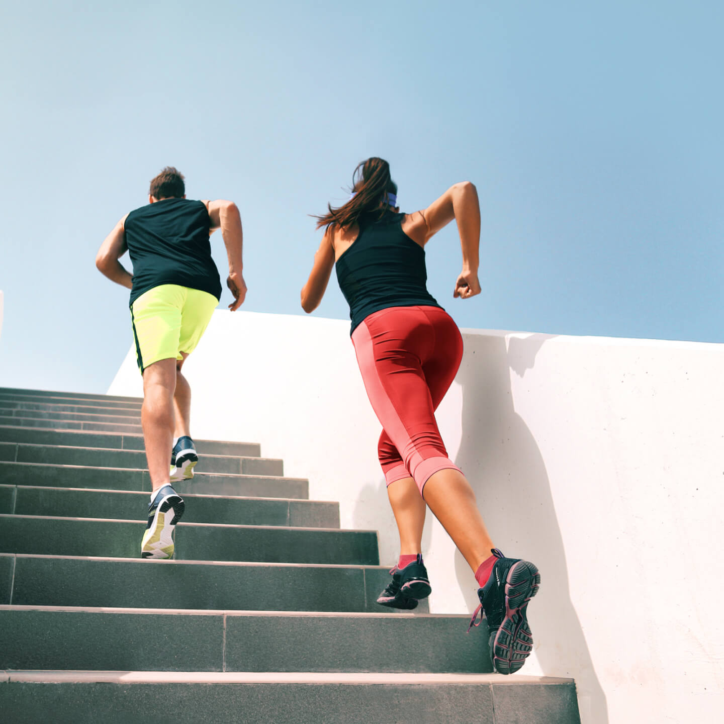 Two people running up stairs