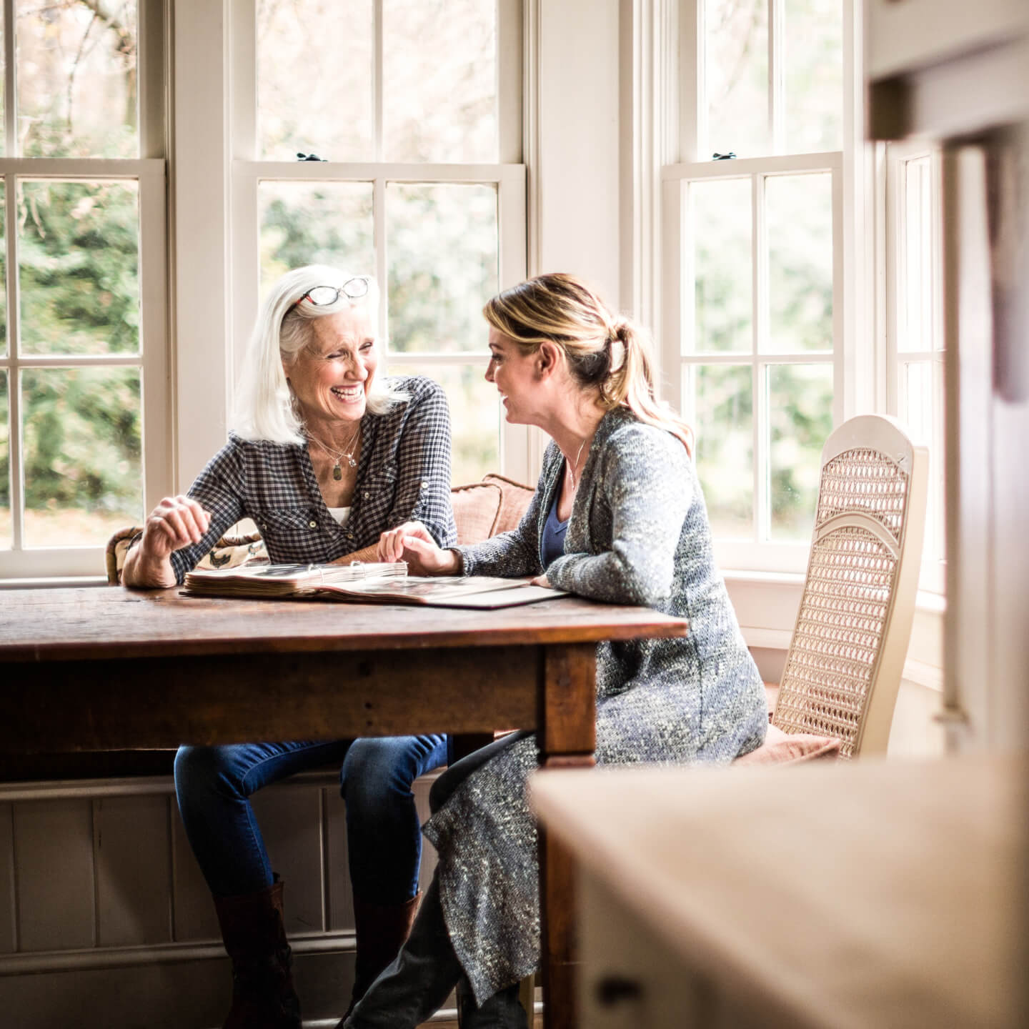 Two women sitting at a table having a conversation.