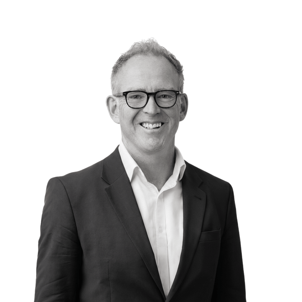 A headshot of board member Tony Macvean