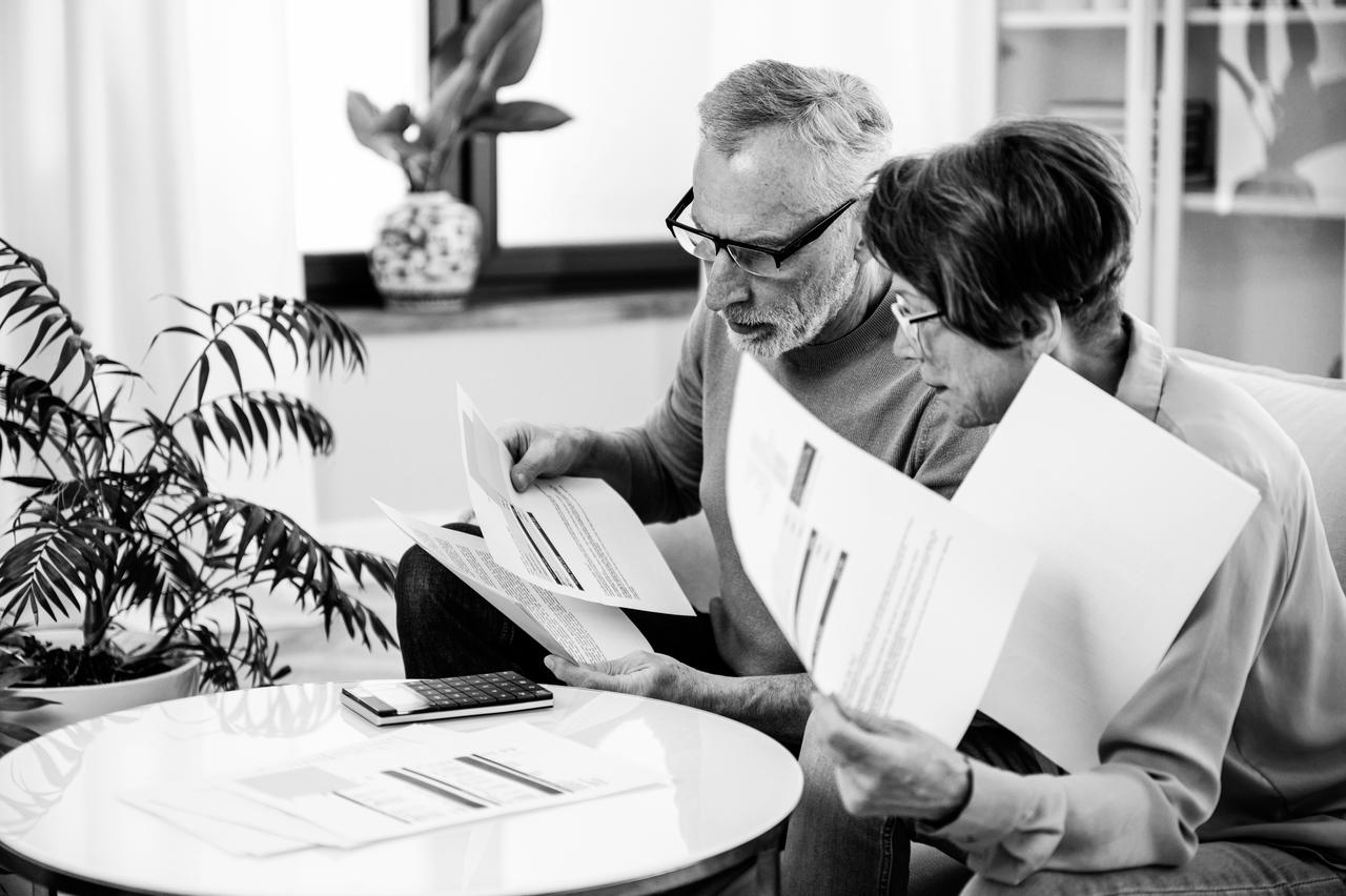 Couple seated at a table checking documents