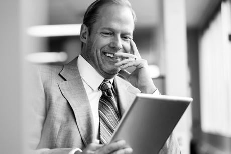 Middle-aged business man in office with tablet computer