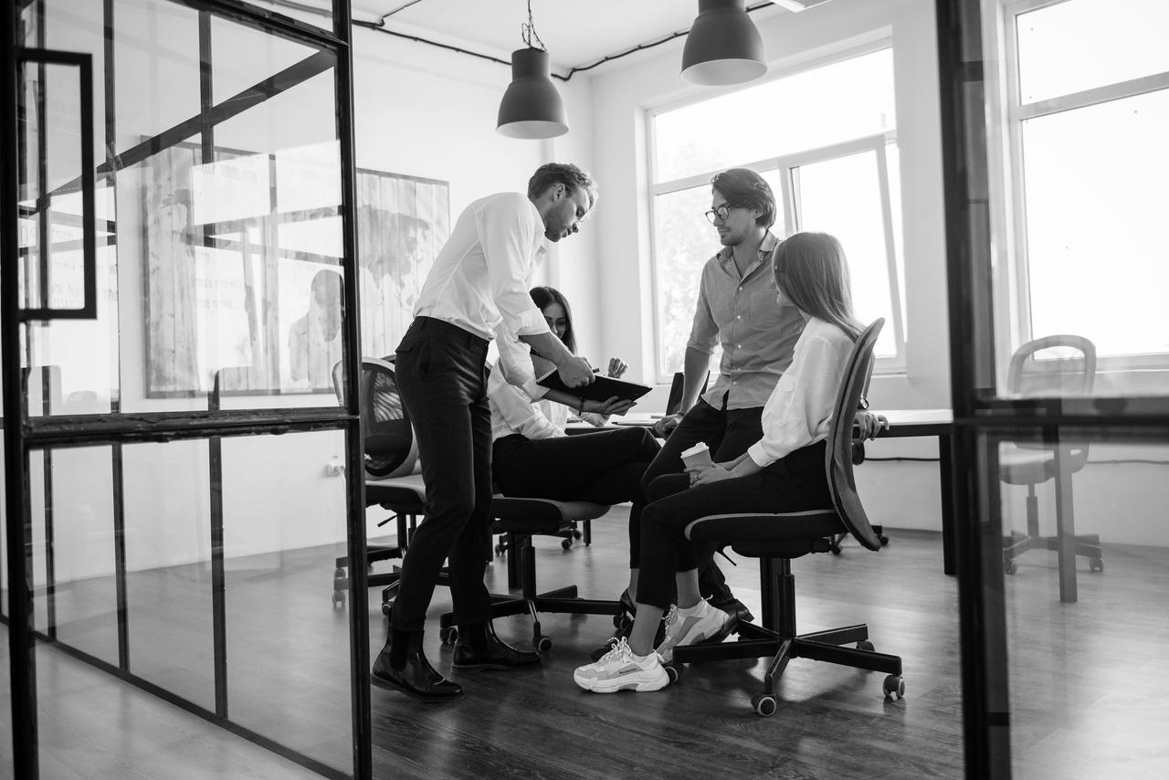 Team meeting in an office Four people are having an informal meeting in the office