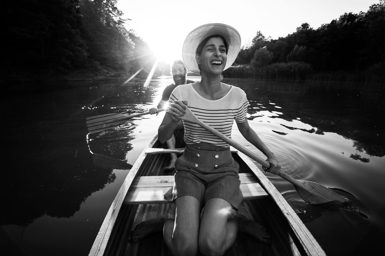 A woman in a boat with a man in the background