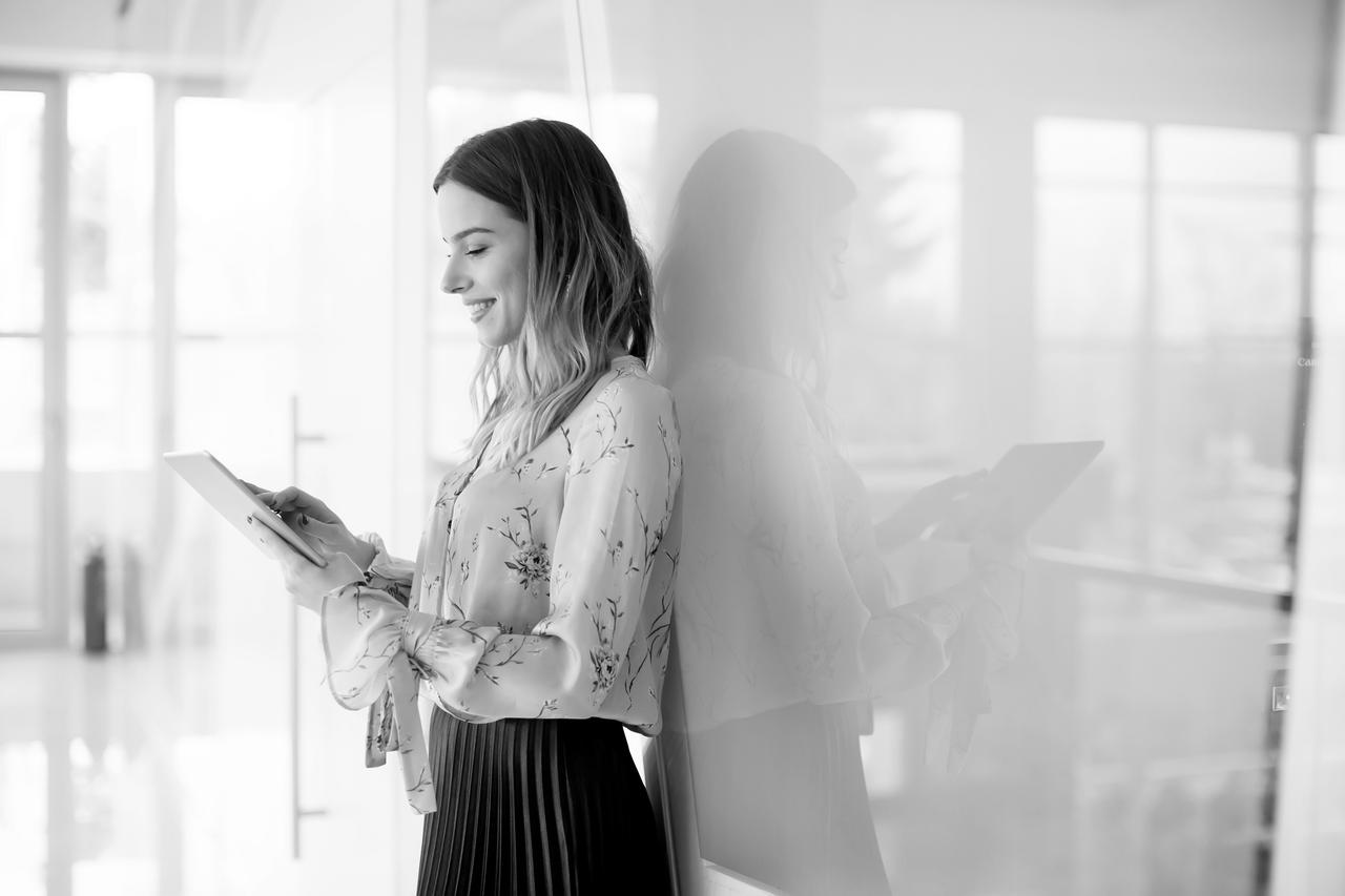 Young businesswoman with tablet in modern office