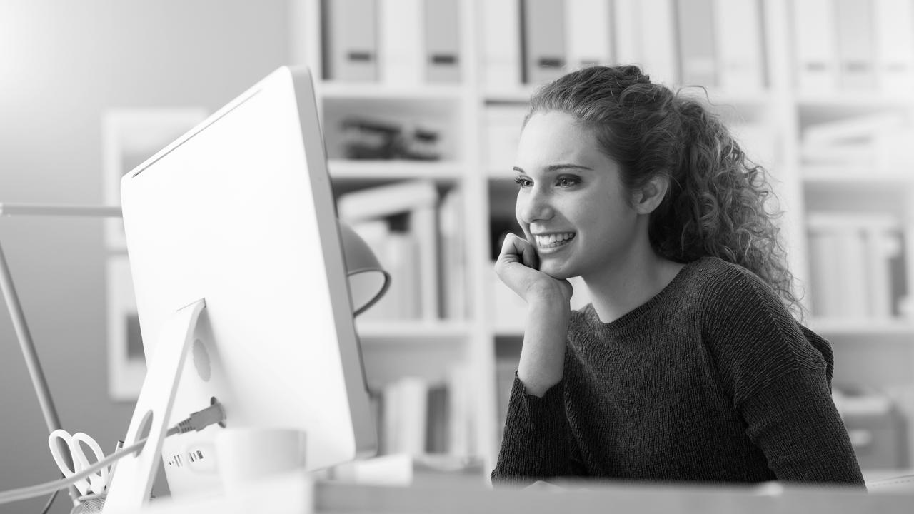 young woman smiling with computer screen 1280x720.jpg