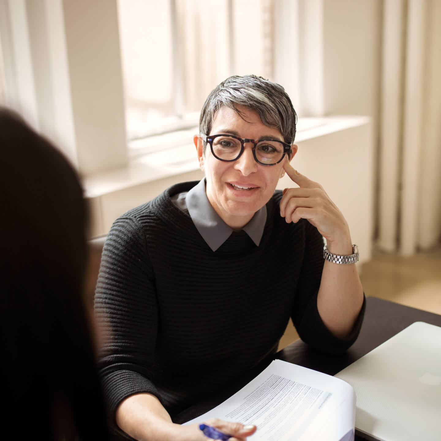 Female worker has conversation with coworker
