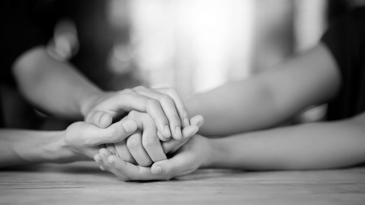 a close-up of a person holding another persons hands